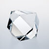 Crystal trophy award with geometric facets on a white surface, ideal for corporate recognition or milestone achievements.