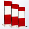 Red tiered crystal trophy with clear center, ideal for corporate or employee recognition, on a clear rectangular base.