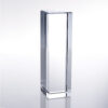Crystal column award trophy standing upright on a light reflective surface, ideal for corporate or employee recognition.