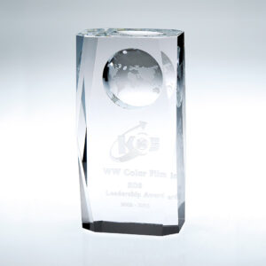 Crystal globe column award with engraved text for corporate leadership recognition, displayed on a white background.
