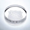 Crystal hockey puck trophy with engraved NHL logo, ideal for corporate or sports achievement recognition.