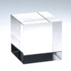 Crystal trophy with sharp edges on white surface, clear glass material; ideal for corporate or employee achievement awards.