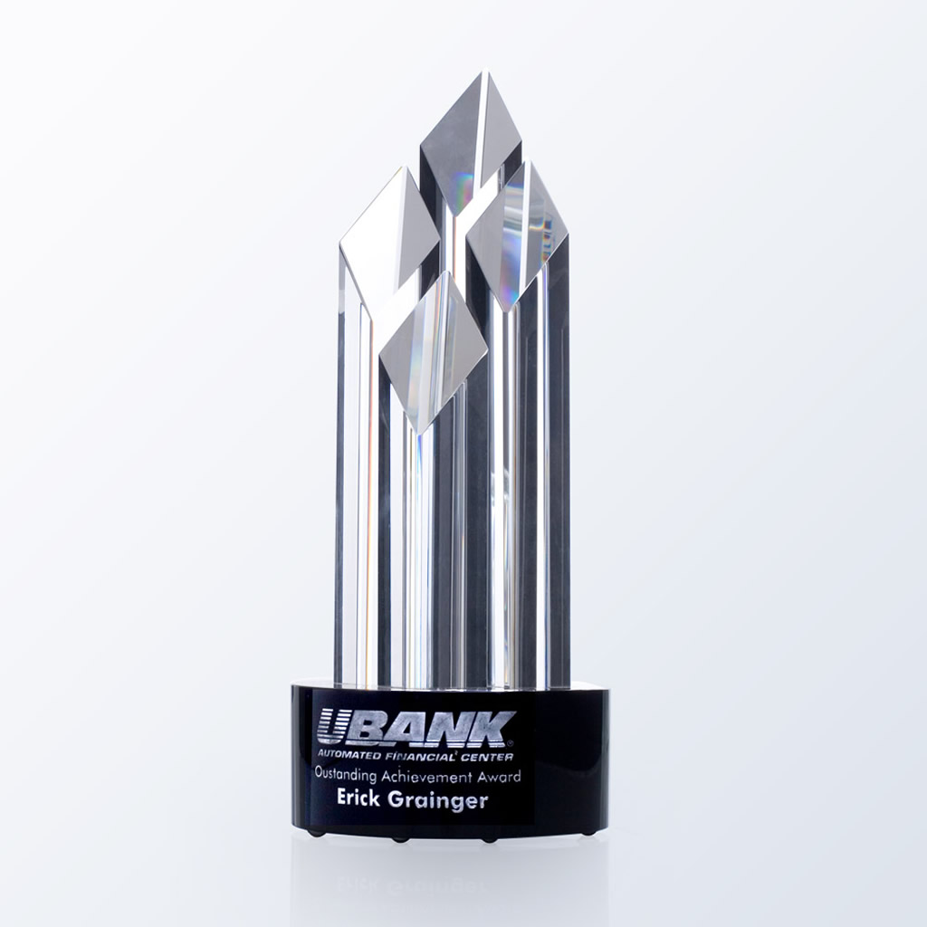 Crystal trophy with geometric facets on black base, engraved for UBANK Outstanding Achievement Award, corporate recognition.