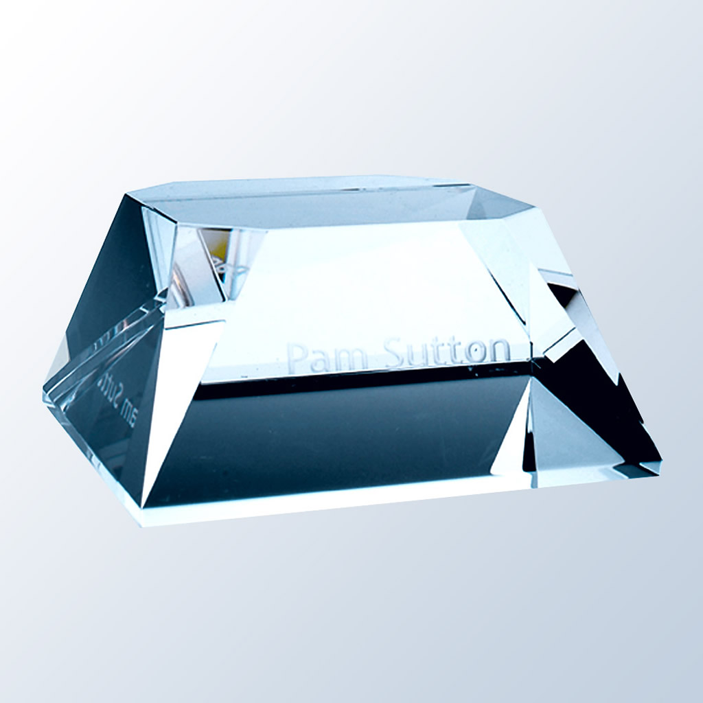 Rectangular crystal paperweight award with beveled slant edges, engraved with "Pam Sutton" for corporate recognition.