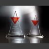 Crystal awards with red accents on reflective base; larger trophy features "Associate of the Quarter Award" engraving.