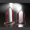 Crystal trophy with red accents, glass material, on reflective surface—ideal for corporate or employee achievement recognition.