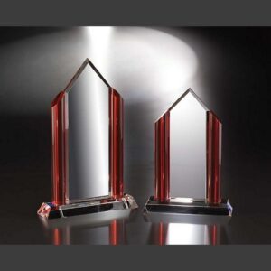 Crystal trophy with red accents, glass material, on reflective surface—ideal for corporate or employee achievement recognition.