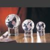 Crystal globe trophies in three sizes on clear bases, ideal for corporate awards or employee recognition.