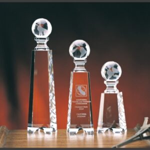 Crystal globe trophies in clear glass, ideal for corporate or employee achievement awards, displayed on a wooden surface.