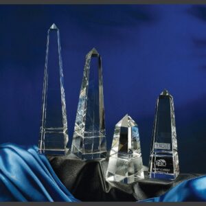 Grooved obelisk crystal trophies in various sizes on satin, ideal for corporate or employee recognition awards.