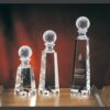 Crystal golf trophy set with golf ball tops, featuring an engraved plaque. Ideal for corporate or sports achievement awards.