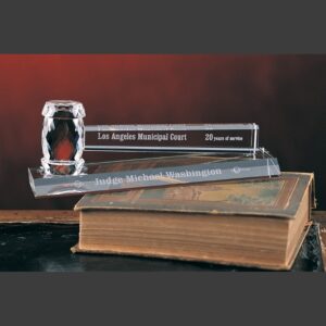 Crystal gavel trophy and engraved nameplate on antique book, commemorating 20 years of service in the Los Angeles Municipal Court.