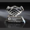 Crystal handshake trophy on engraved base, ideal for partnership or corporate achievement recognition.