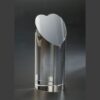 Crystal heart-shaped trophy award, cylindrical design on dark surface, ideal for employee or corporate recognition.