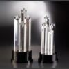 Crystal star awards with transparent pillars on black bases, ideal for corporate recognition or employee achievement.