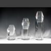 Crystal trophy awards made of clear geometric glass, with engraved Natalie Crystal Award for corporate or employee recognition.
