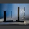Crystal award trophy with black base, engraved for corporate recognition; shown blank and personalized with a name.