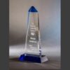 Blue crystal obelisk trophy with engraved text, ideal for corporate leadership or achievement recognition awards.