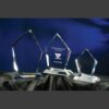 Summit crystal awards in three sizes on black cloth, center engraved for corporate achievement, ideal as manager trophies.