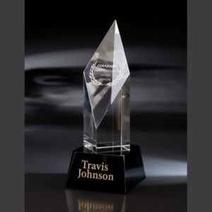 Crystal trophy with pointed top on black base, gold engraving for outstanding achievement, ideal for corporate recognition.