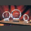 Faceted crystal awards on clear bases for Teacher of the Year recognition, ideal for corporate or academic achievement.