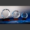Crystal trophy awards with faceted edges on dark bases, featuring engraved logo and recipient name for corporate recognition.