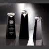Black crystal trophy pedestals with solitaire crystal awards, tallest engraved "PIKA Presents The Diamond Award" for recognition.