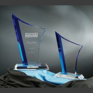 Vertigo Crystal Awards with blue accents on fabric, corporate trophy engraved for excellence and achievement.