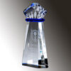 Crystal trophy with geometric faceted top, blue accent, and engraved front text, ideal for corporate recognition awards.