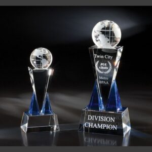 Crystal globe trophies with blue accents on a reflective surface, featuring a corporate champion crystal award.
