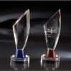 Crystal star awards with angular tops on round bases, blue and red accents; ideal for corporate or employee recognition.