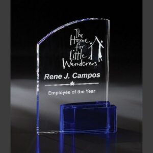 Crystal award trophy with blue base, etched for Employee of the Year at The Home for Little Wanderers.