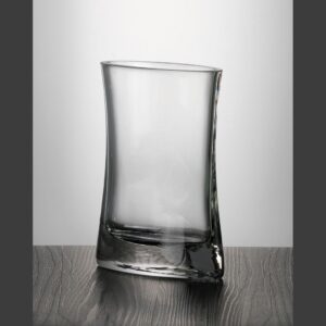 Curved asymmetrical crystal trophy award on dark surface, ideal for corporate recognition or milestone achievement.