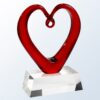 Crystal heart trophy with open center on clear base, ideal for corporate recognition or employee achievement awards.