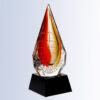 Crystal teardrop award with red and yellow accents, glass material on black base, ideal for corporate or employee recognition.
