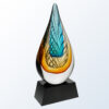 Crystal teardrop award with blue and amber swirls on a black base, ideal for corporate or employee recognition.