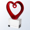 Crystal heart award on clear glass base, ideal for employee recognition or corporate milestone achievements.