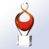 Crystal trophy with red and yellow twisted ribbon design on clear rectangular base, ideal for corporate or achievement awards.
