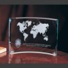 Crystal plaque with etched world map, LAPD badge, and appreciation inscription, displayed on wood surface.