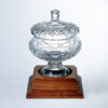 Crystal trophy with lid, Mercedes-Benz engraving, on polished wood base; ideal corporate or employee recognition award.
