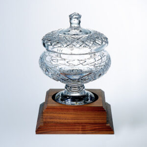Crystal trophy with lid, Mercedes-Benz engraving, on polished wood base; ideal corporate or employee recognition award.