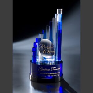 Crystal award with blue and clear glass columns, gold text for 15-year milestone recognition, corporate achievement trophy.