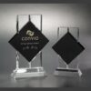Black crystal trophy awards on clear bases, ideal for corporate recognition or employee milestones, one engraved and one blank.