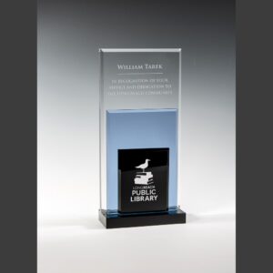 Crystal trophy engraved for William Tarek recognizing community service, features Long Beach Public Library logo at base.