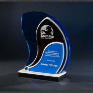 Blue and clear crystal trophy with white base, engraved for leadership achievement, featuring horse logo and recipient's name.