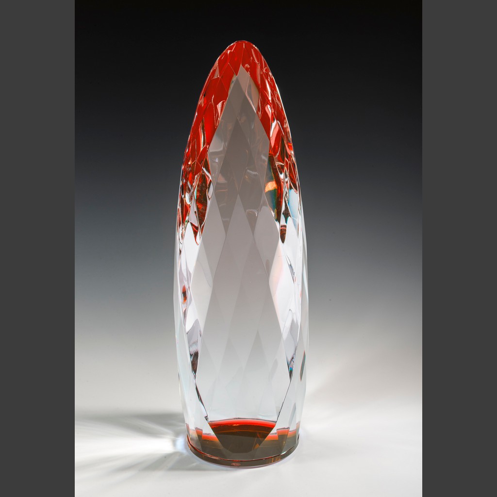 Red crystal trophy with faceted diamond surface, red accents, and pointed top, ideal for corporate achievement recognition.
