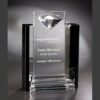 Crystal trophy with diamond top, etched "Team Member of the Quarter, Joseph Martinez," on glass base. Employee recognition award.