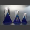 Geometric crystal trophies with blue bases, ideal for corporate or employee recognition awards.