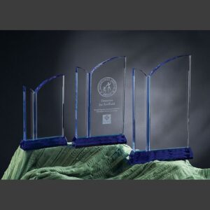 Ocean Drive crystal awards with blue bases, center trophy engraved, ideal for corporate recognition or employee achievements.