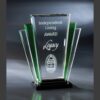 Crystal trophy with green accents, etched “Independent Living Award Legacy” and house logo on black base, for corporate recognition.